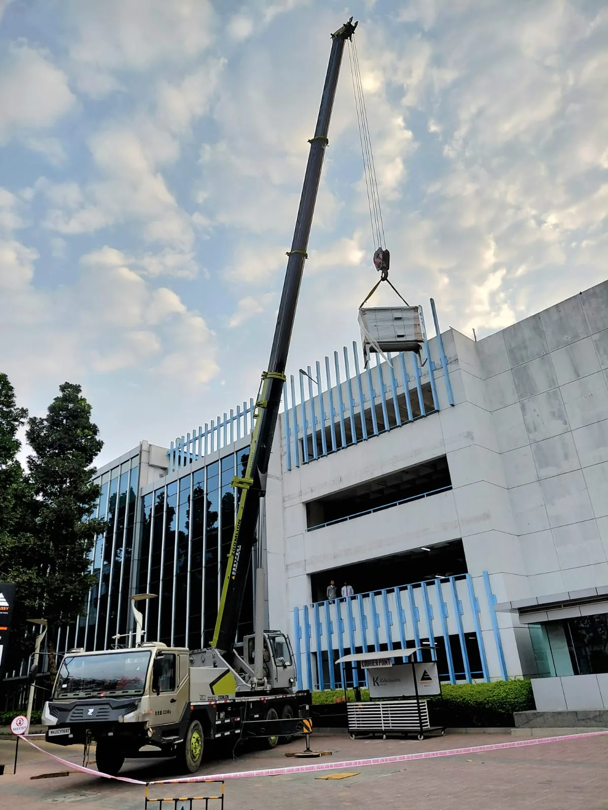 Extended crane boom beside a building