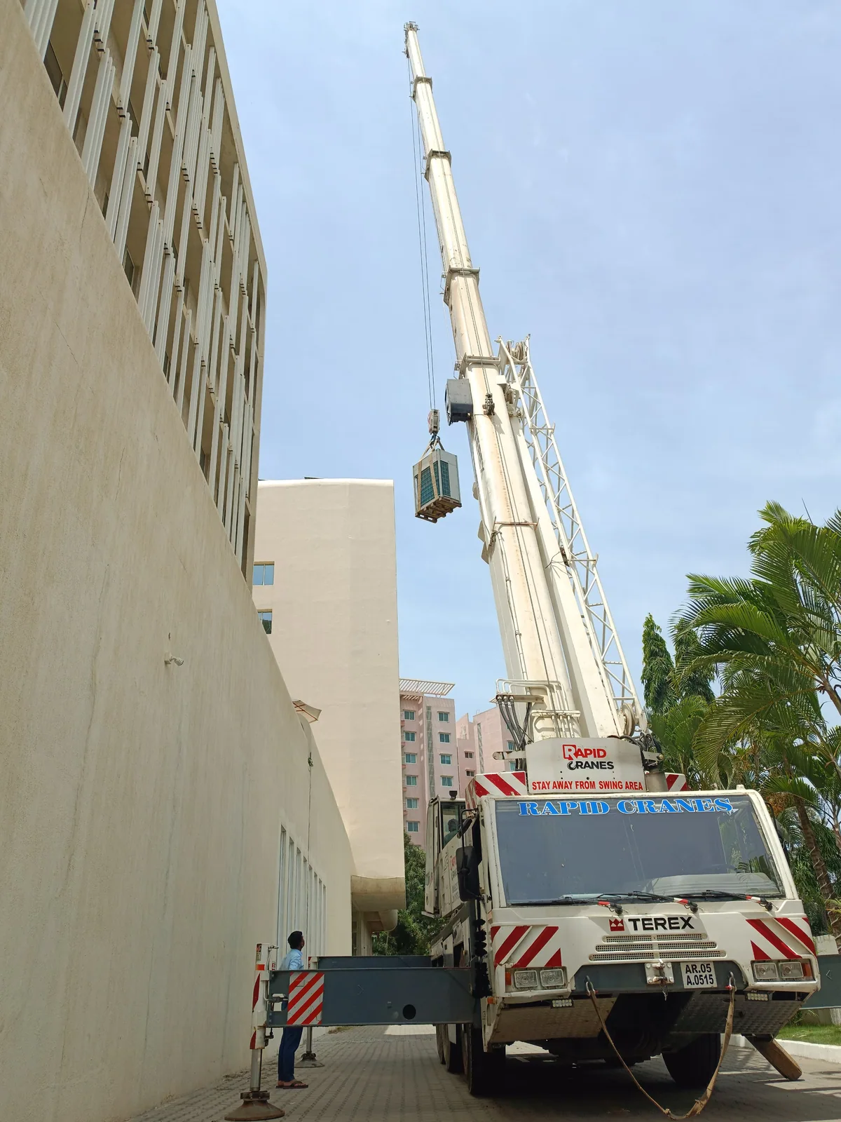Crane extended alongside a building