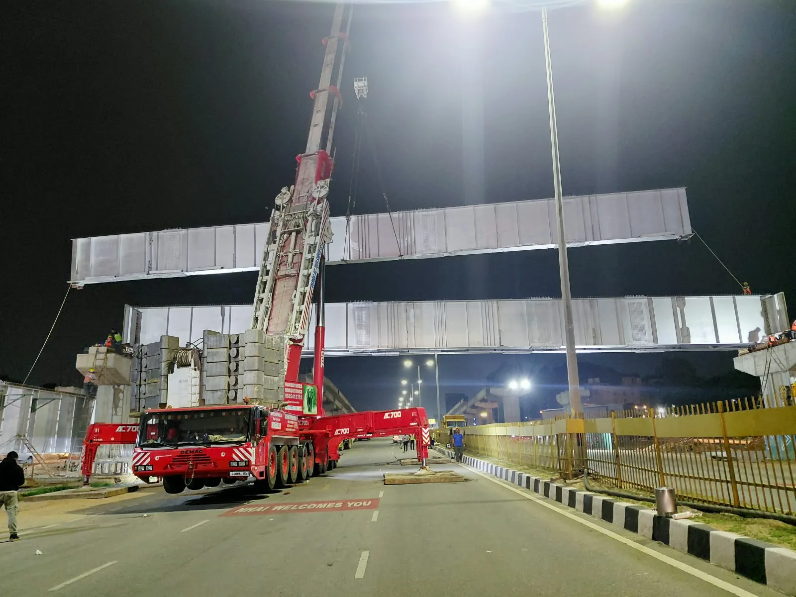 AC 700 ton crane positioning an ROB girder at night for airport access